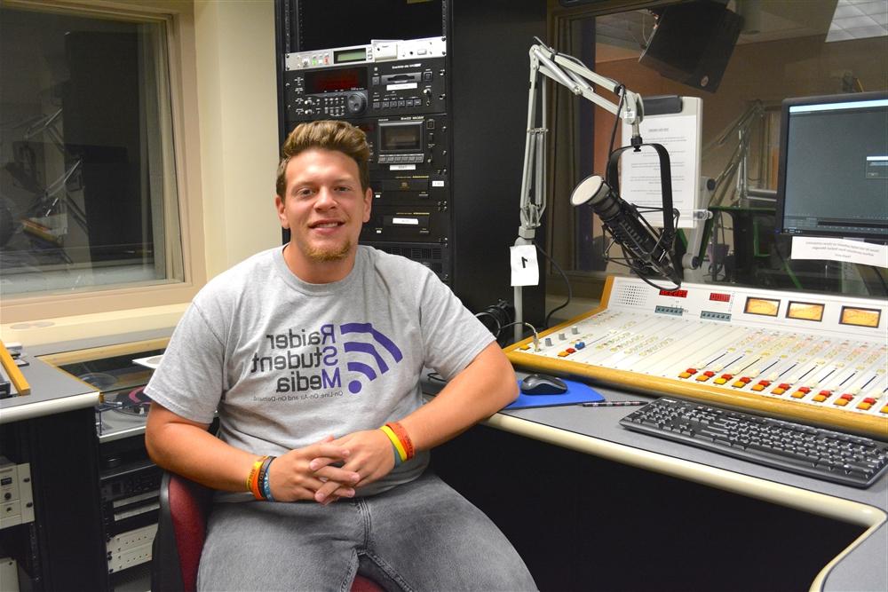 Joe Mertens sitting in a radio station booth 